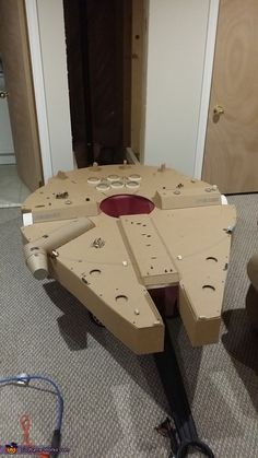 a table made out of cardboard sitting on the floor