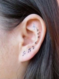 a woman's ear with musical notes on it