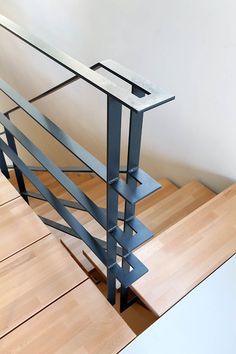 a wooden table with metal railings on it's sides and wood flooring