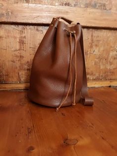 Bucket bag Leather bucket bag Hobo bag Crossbody leather bag, Hobo shoulder bag, Soft leather bucket bag, Drawstring leather purse, Woman purse,  Brown, elegant and soft leather bucket bag, large enough to carry around all the things you might need around during your day. Carefully handcrafted into the perfectvsize to get all your stuff around just nice. Safely closing with a leather string. You can either wear it as a cross body or shoulder bag.  This bag is exclusively handcrafted. The leather is manually and precisely cut having every hole individually punched. Afterwards, with close attention to details, the bag is assembled and sewed by hand. *note that I do not add any fabric linings to my bags - the inside is pure leather. Height: 30 cm / 10.6 inch Diameter: 21 cm/ 8.26 inch   Non-A Leather Bucket Satchel For On-the-go, Brown Bucket Bag For Everyday Use, Soft Leather Bucket Bag For Everyday Use, Everyday Soft Leather Bucket Bag, Leather Bucket Bag For Everyday Use, Leather Hobo Tote Bag With Mobile Phone Bag, Everyday Bucket Satchel With Mobile Phone Bag, Leather Hobo Shoulder Bag With Mobile Phone Bag, Everyday Bucket Shaped Satchel With Mobile Phone Bag