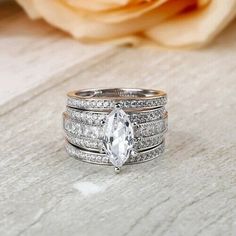 a close up of a ring with a flower in the background