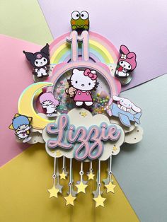 an image of a hello kitty clock on the side of a rainbow colored wallpaper