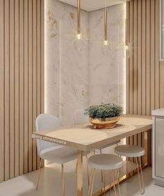 a dining room table with chairs and a potted plant