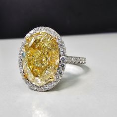 6.16 carat center Fancy Light Yellow Diamond Oval Cut VS1 Clarity GIA Certified Diamond Excellent + Very Good cutting Surrounded by 0.69 Carats of White Diamonds Set in Platinum & 18k Handmade in NYC Ready to Ship Oval Canary Yellow Diamond Ring, Oval Yellow Diamond Ring, Oval Yellow Diamond Engagement Ring, Canary Diamond Engagement Ring, Canary Diamond Ring, Dig Jewelry, Yellow Sapphire Ring Engagement, Oval Halo Diamond Ring, Fancy Yellow Diamond Ring