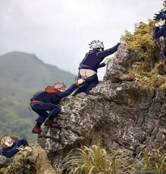 two people climbing up the side of a mountain with one person reaching for another man's head