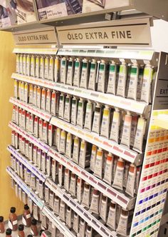 the shelves are filled with different types of paint and glues for sale in a store