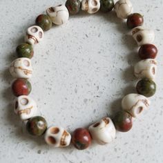 Unakite And White Howlite Skulls Bracelet. Perfect For Stacking! Handmade. Stretch Cord. Unisex. One Size. Ideally Fits Wrist Size 6.5" To 7.5". **For The Perfect Fit, Please Comment With Your Wrist Measurement For More Designs, Check Out 87rockwooddesign On Etsy! *Veteran Owned And Operated *A Portion Of Sales Will Be Donated To A Veteran Charity Power Bracelet, Red Beaded Bracelet, Caged Necklace, Lava Bead Bracelet, Skull Pendant Necklace, Hematite Bracelet, Skull Bracelet, 5 To 7, White Howlite