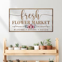 a wooden sign that says fresh flower market blooms stems seeds and succulents