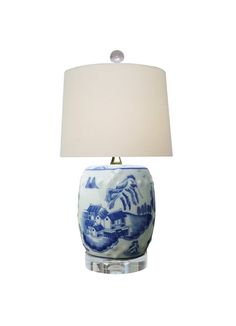 a blue and white lamp with a shade on it