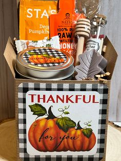 a box filled with lots of food on top of a wooden table next to other items