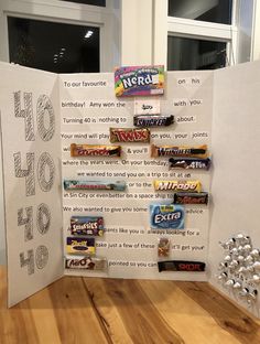 a candy bar display in the shape of a sign with words written on it and candies