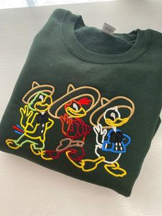 Hoodie Embroidery, Embroider Ideas, Three Caballeros, Disney Epcot, Embroidery Tshirt, Disney Hoodies, Disney Sweatshirts, Embroidered Crewneck, Embroidered Sweatshirt