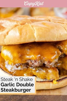 a close up of a sandwich on a wooden table with text overlay that reads steak n shake garlic double steak burger