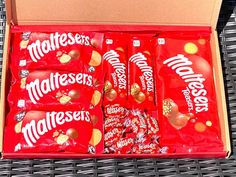 a box filled with lots of red and gold candy