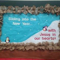 a bulletin board with penguins on it and the words sledding into the new year