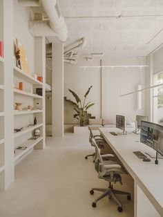 an empty office with desks and computer screens