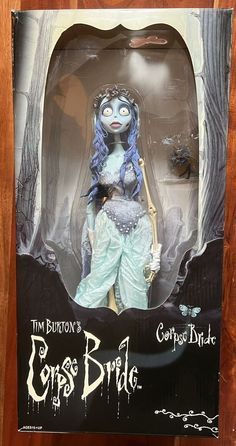 the corpse bride doll is on display in a wooden frame with an advertisement for corpse bride