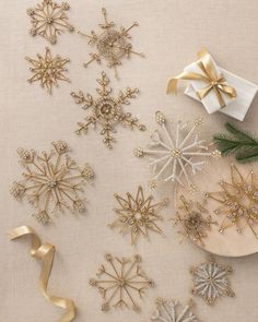 some gold and silver snowflakes on a table