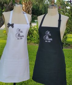 two aprons that are on display in the grass