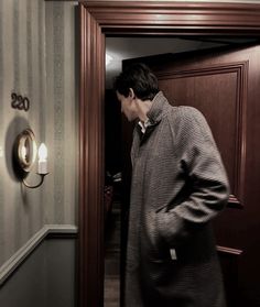 a man standing in front of a wooden door