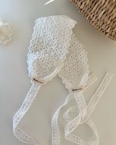 the white crocheted lace is next to a basket