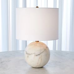 a marble table with a white lamp on it