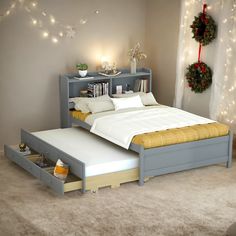 a bedroom with a bed, night stand and christmas wreath