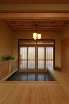 an empty room with wooden flooring and sliding glass doors