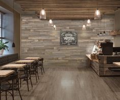 an empty restaurant with wooden tables and chairs