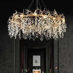 a chandelier hanging from the ceiling in a room with black walls and flooring