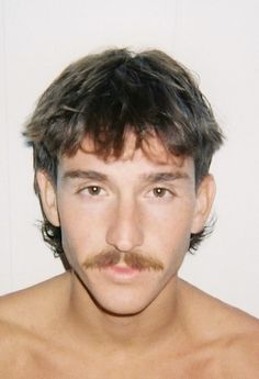 Guy With Mullet And Mustache, Short Men Mullet, Men’s Haircuts Widows Peak, Moptop Haircut Men, Mod Men’s Hair, Haircuts For Guys With Round Faces, Mullet Mustache Combo, Baby Mullet Haircut Men, Facial Hair Styles Men