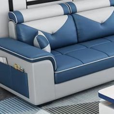 a blue and white couch sitting in a living room