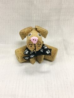 a brown dog with a black bow tie sitting on top of a white cloth covered surface