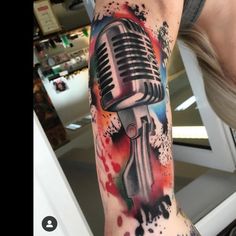 a person with a tattoo on their arm has a microphone in the middle of his arm