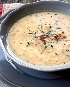 a bowl of soup on a plate with a spoon