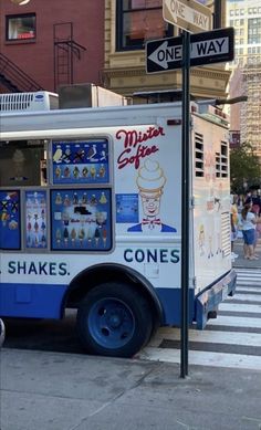 an ice cream truck is parked on the side of the street