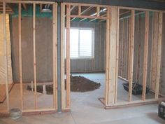 an unfinished room with wooden framing and walls