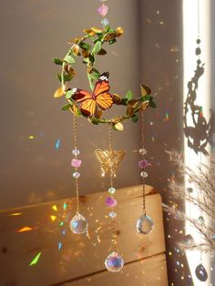 a butterfly mobile hanging from the ceiling next to a window with sunlight streaming through it