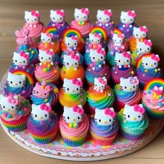 hello kitty cupcakes with rainbow frosting and sprinkles on top