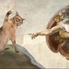 a cat standing on top of a painting next to a man's hand with the creation of adam