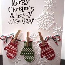 a christmas card with mittens hanging from clothes pins