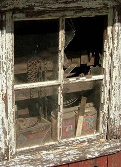 an old window with broken glass in it