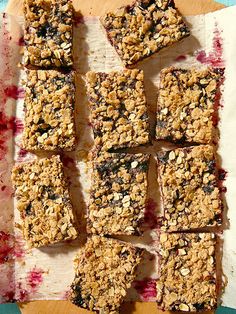 several squares of granola on a piece of parchment paper