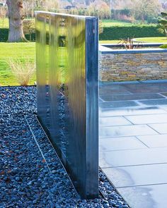 a metal sculpture sitting on top of a gravel field