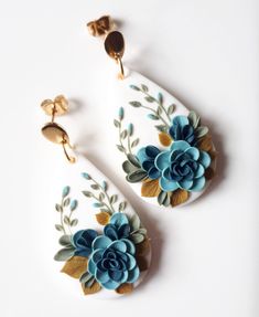 two pairs of earrings with flowers painted on them