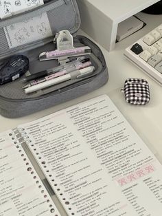 an open suitcase sitting on top of a desk next to a keyboard