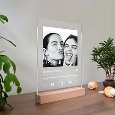 an image of two women sharing a moment together on the screen with headphones in front of them