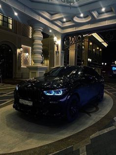 a black car parked in front of a building