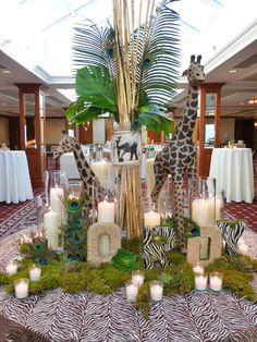 two giraffes are standing next to candles on a table