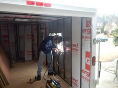 a man is working on the inside of a building with tools in hand and an electric drill